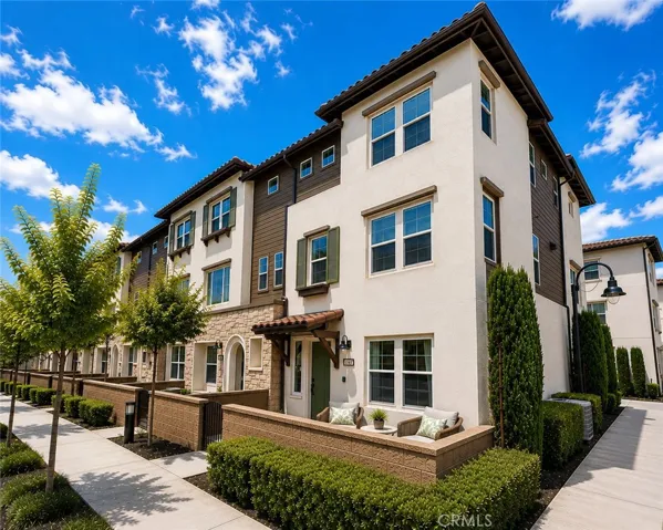 Front daytime elevation with virtually staged outdoor furniture