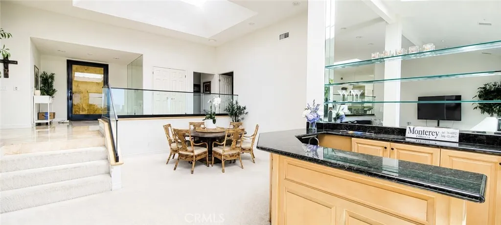 Great Open-Floor Plan Boasts a Bar with Granite Counter Top and Glass Shelving.