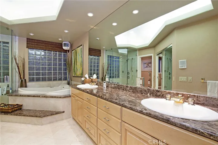 Primary Bathroom Offers Upgraded Cabinetry, Granite Counter-Top, Spa-Tub & a Walk-In Shower.