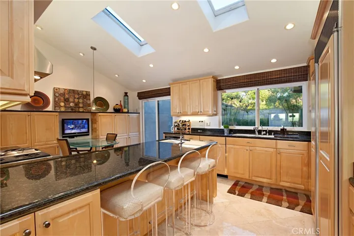 Chef's Kitchen Featuring Upgraded Cabinets, Granite Counter-Top, 2 Skylights, Two Sinks and Hi-End Appliances.