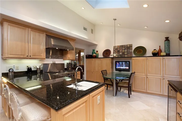 Upgraded Chef's Kitchen Boasts a built-in Table and top-Of-The-Line Appliances.