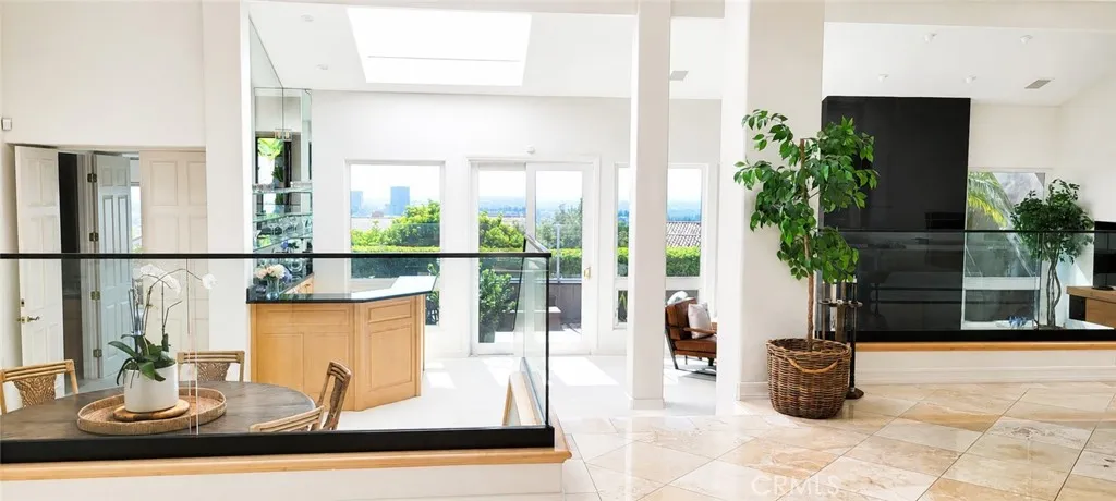 Single Level residence offers Travertine Floor, Volume Ceiling, Three Skylights and Breathtaking Ocean & City Light View.