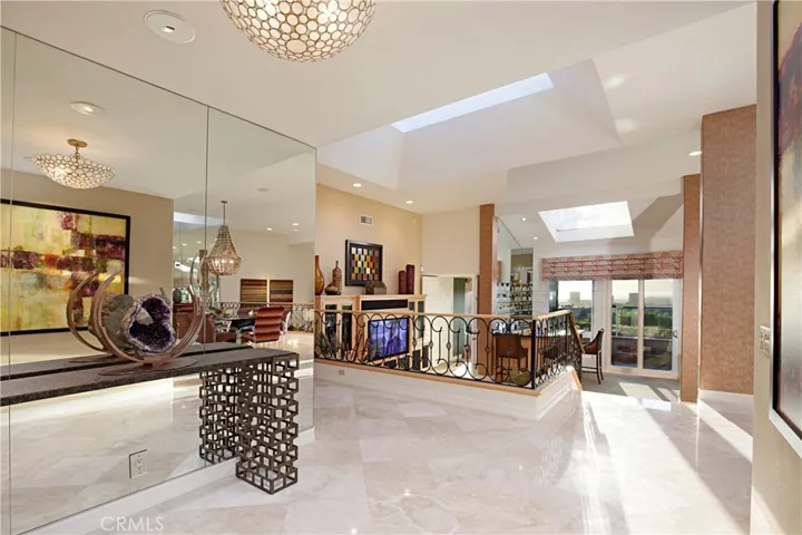 Elegant Entry Foyer Leads to a Beautiful Open Floor Plan, Neutral Decor., Volume Ceiling. (Previous Wrought Iron Railing is Replaced with an Upgraded Glass Railing)