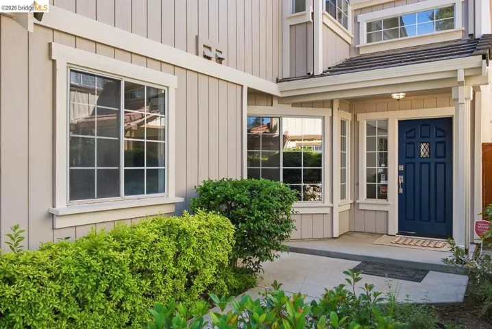 Entryway featuring a paneled door with decorative glass inserts, sidelight windows, and an overhead light fixture