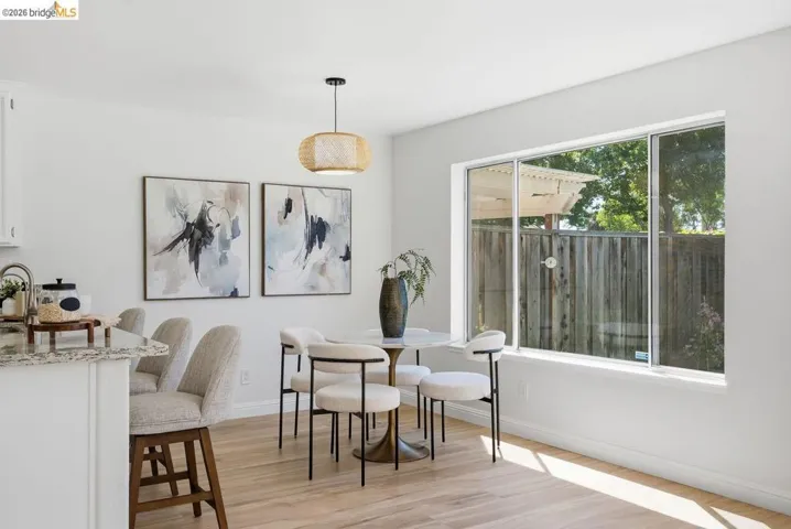 Bright dining area featuring wood-finish flooring and a large window