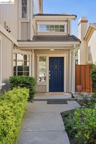 Welcoming front entrance featuring a panel door, side windows, and transom window