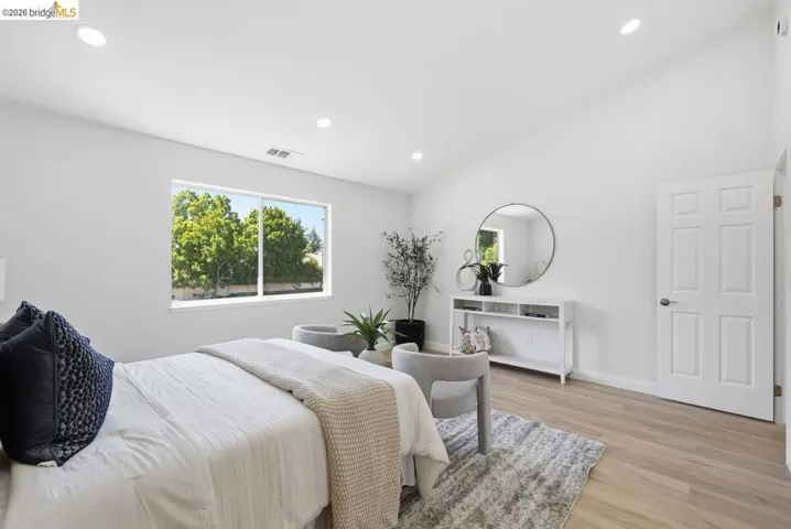 Bright interior space featuring a vaulted ceiling and recessed lighting