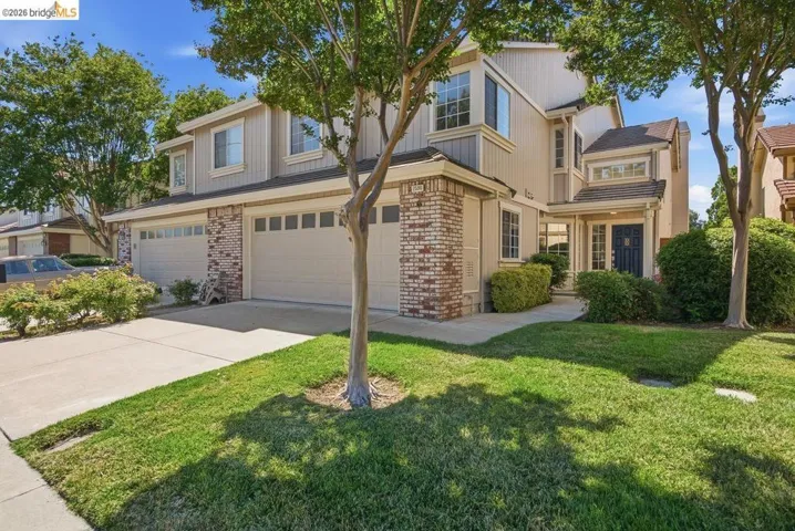 Beige siding exterior with brick accents