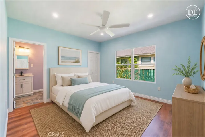 (primary bedroom with ensuite bath virtually staged)
