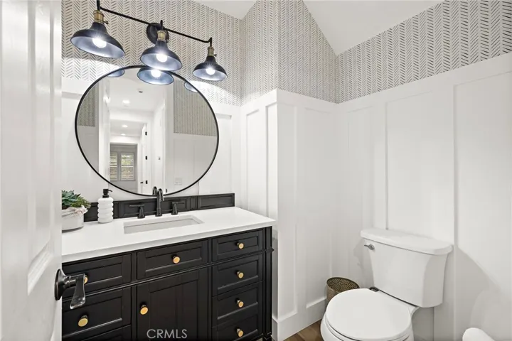 Remodeled powder room w/wood paneled walls