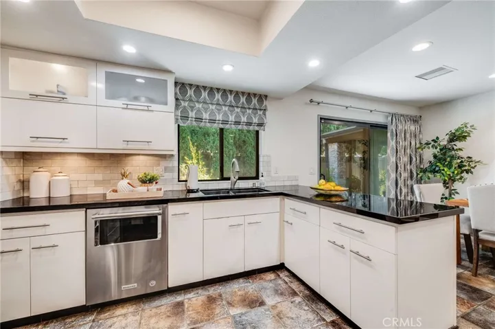 Contemporary Custom Cabinets with Soft Close Drawers and Cabinets, Marble Backsplash, and Black Granite Countertops