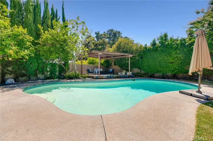 Beautifully Landscaped Backyard with Spacious Patio Area, Pool, Terraced Deck and Gazebo, and lots of privacy