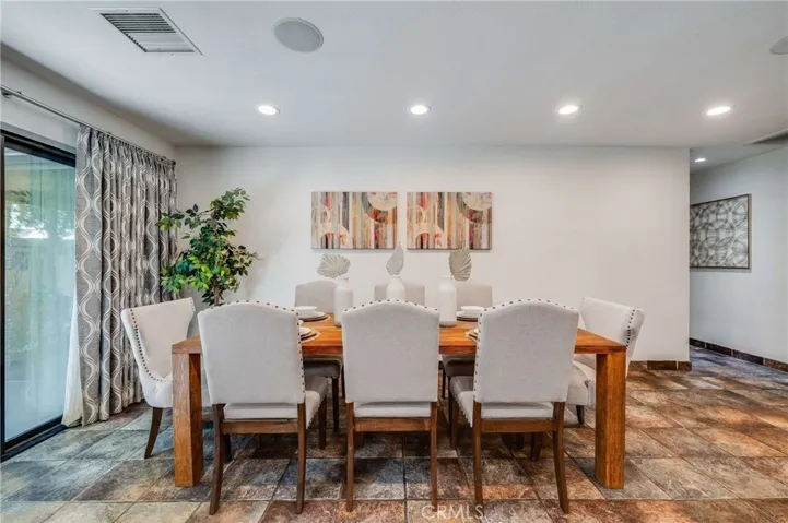 Dining Area off of Kitchen and Living Room with Sliding Glass Door that leads to Covered Patio