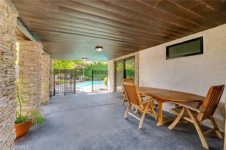 Covered Patio that leads to Backyard and Pool Area