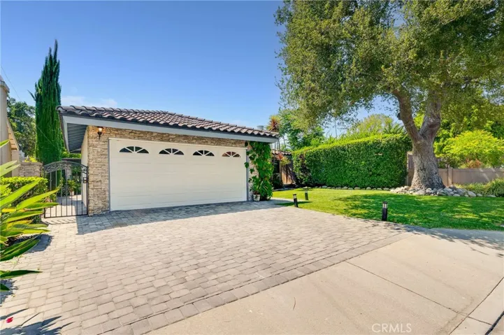 A 2 car Garage compliments the beautiful Concrete Paver Driveway