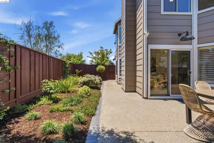 Expansive concrete patio with direct access to interior spaces via sliding glass doors