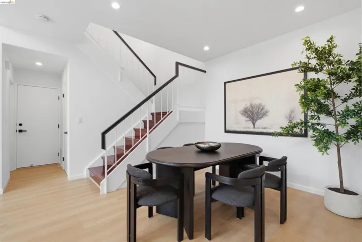 Open concept dining area featuring light wood-finish flooring