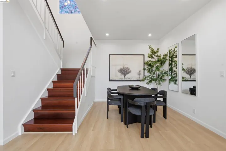 Hardwood staircase with white balusters and dark wood handrails