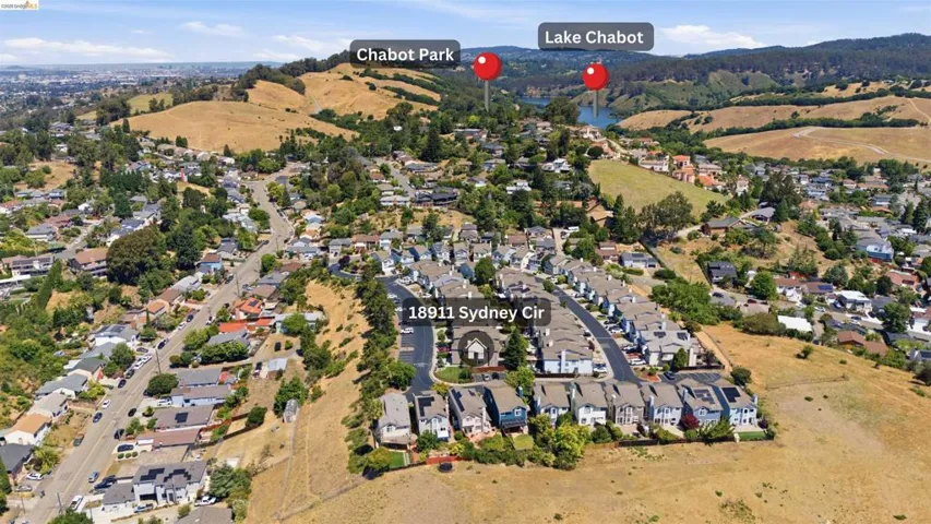 Aerial perspective showcasing a residential community amidst rolling hills and green spaces