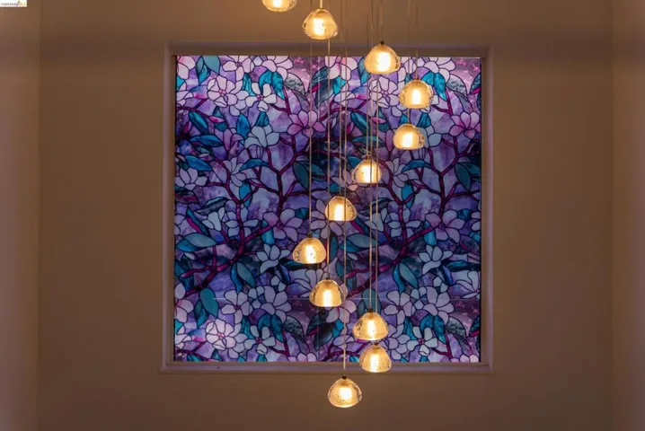 Decorative window with a floral pattern and a multi-light pendant fixture