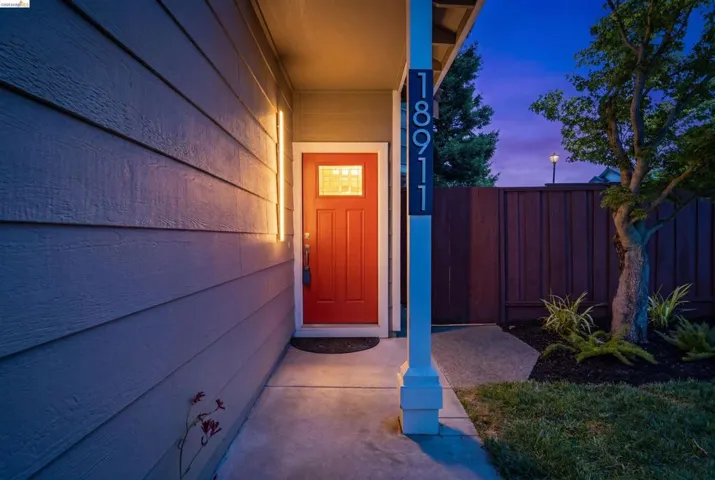 Red paneled entry door with transom window