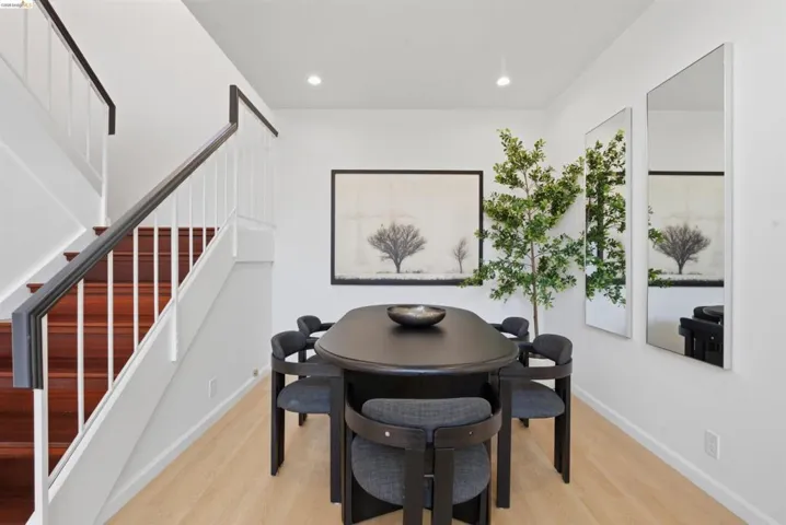Dining area featuring light wood-finish flooring and recessed lighting