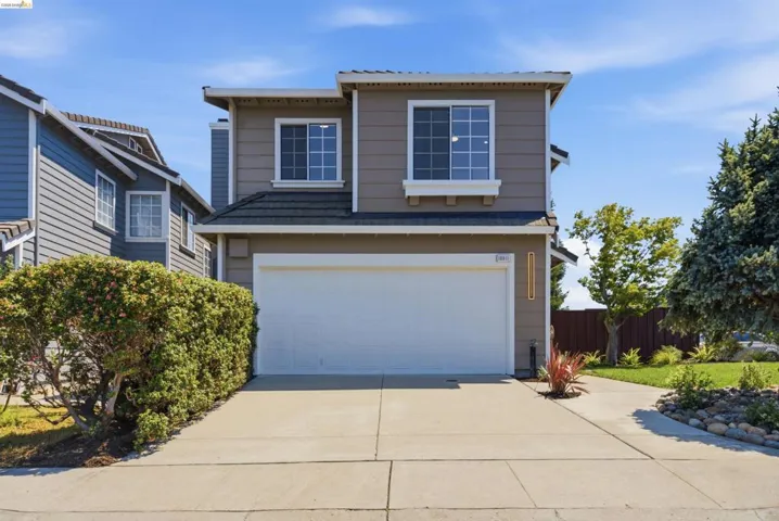 Two-story residence featuring a neutral-toned exterior with white trim