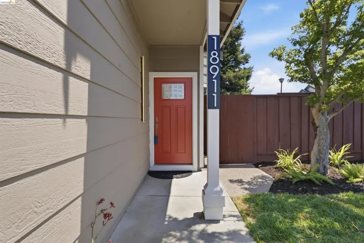 Inviting front entry featuring a vibrant red door with glass paneling