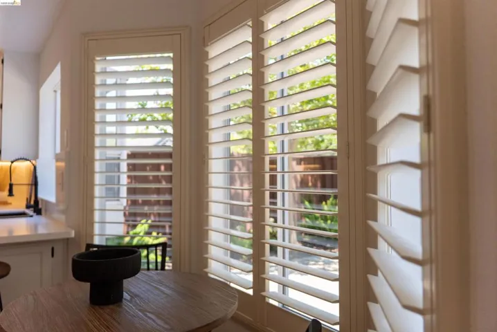 White plantation shutters adorning multiple windows, offering controlled light