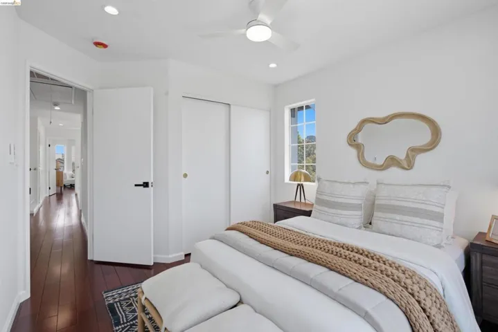 Bedroom featuring rich wood-finish flooring and bright white walls