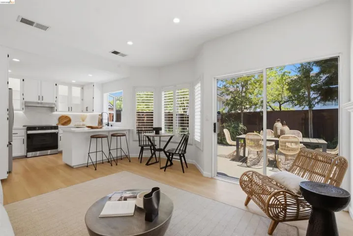 Open-concept living area with wood-finish flooring and recessed lighting