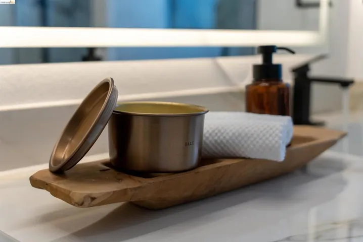 Matte black faucet with a coordinating soap dispenser, set against a white countertop with subtle veining