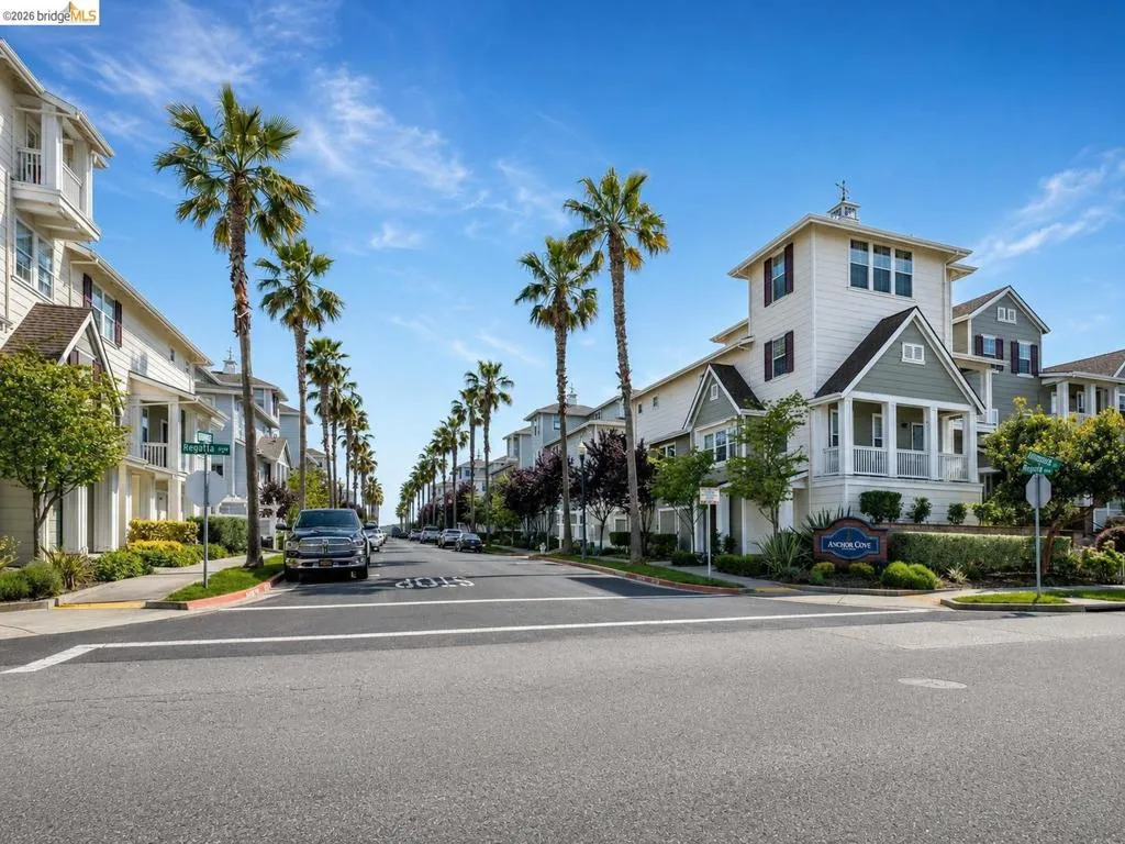 Streetscape featuring a row of residential buildings with varied architectural details and a consistent street presence