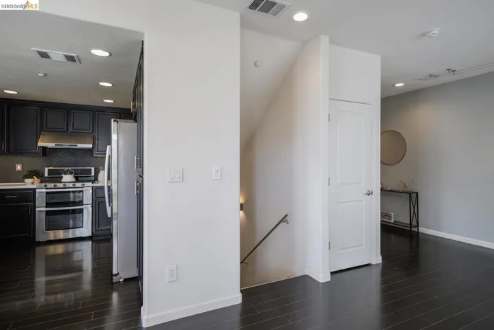 Dark wood-finish flooring extending through the space