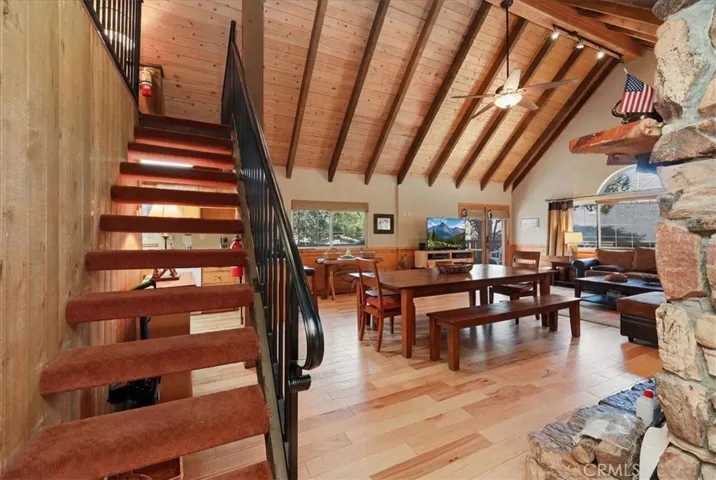 Staircase leading to the loft with an open view of the living and dining area.