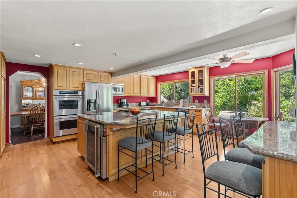 Chefs kitchen with seating on the island and seating looking into family room.