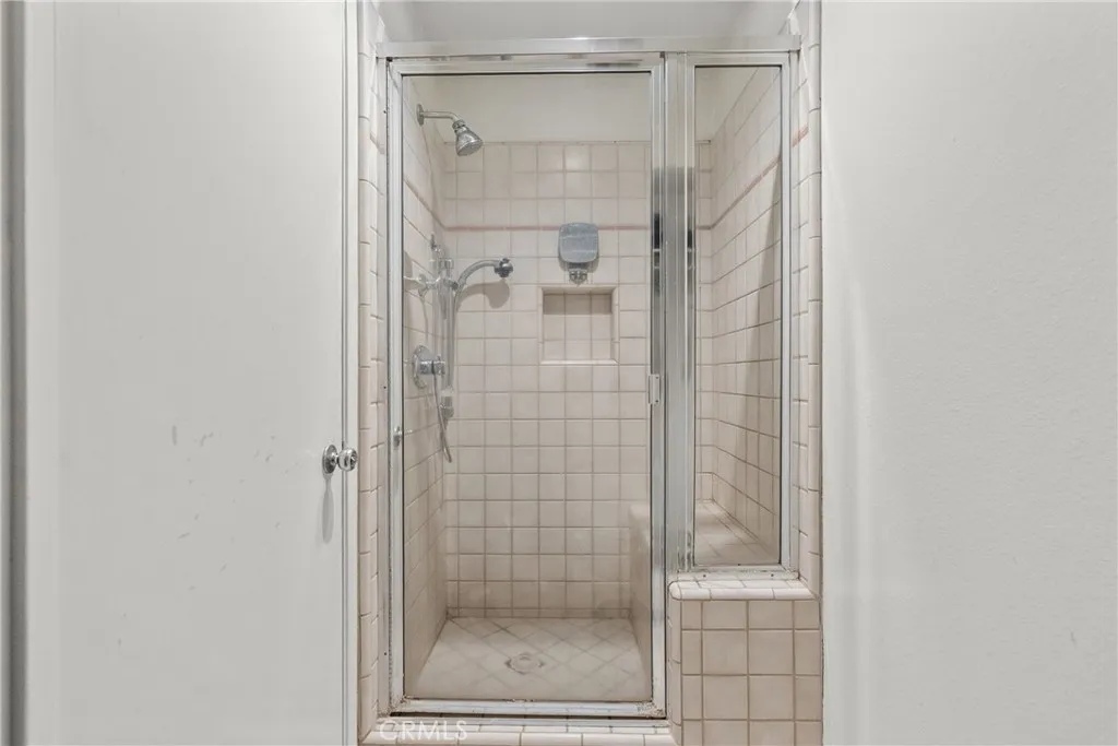 Walk in primary shower with bench seat.