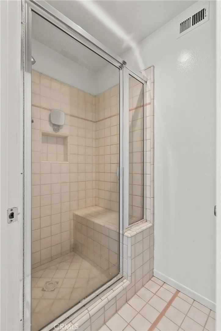 Walk in shower with bench seat.