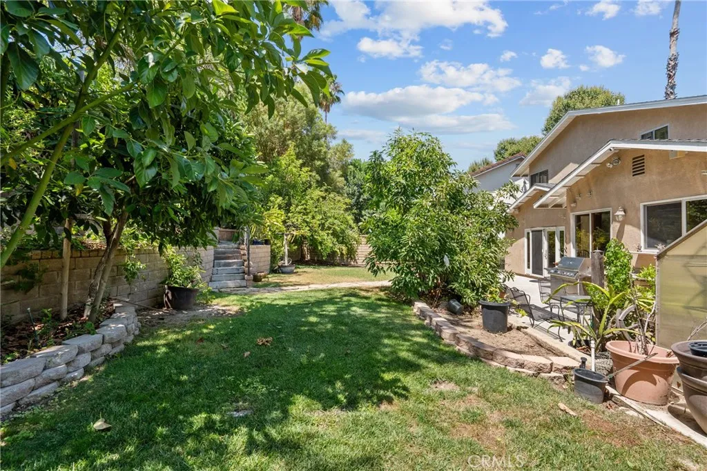 Grass area and steps to upper area of yard.