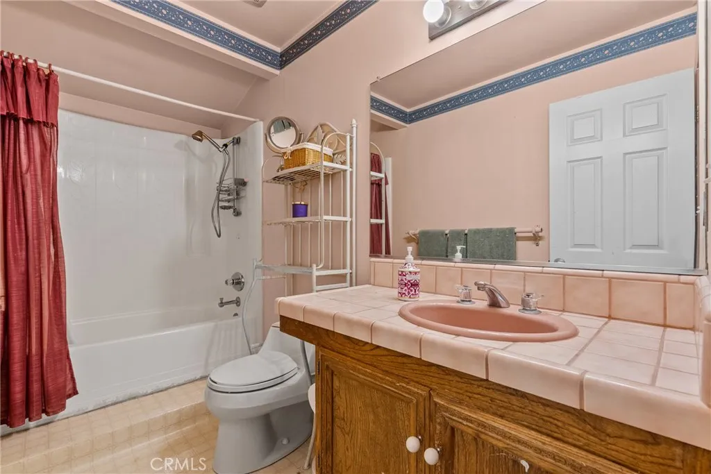 Bathroom with bath tub and shower combo.