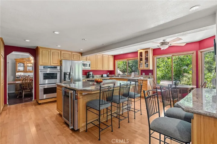 Chefs kitchen with seating on the island and seating looking into family room.