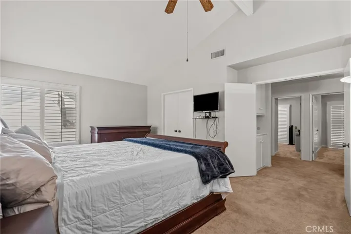 Primary bedroom suite with vaulted ceiling.