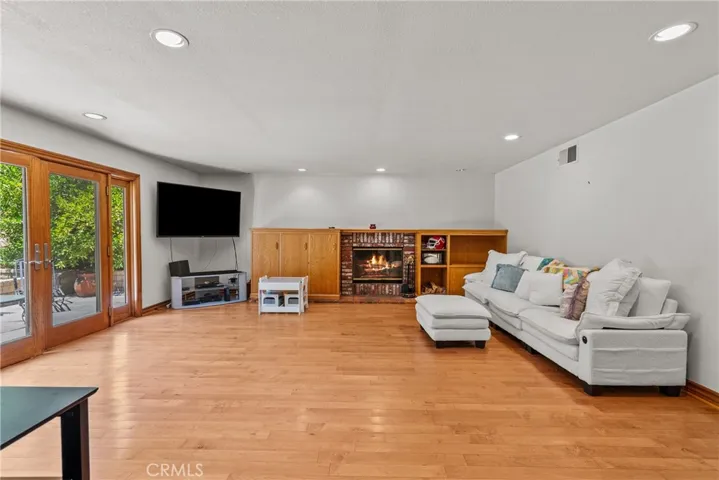 Family room with fireplace and sliding glass door into backyard.