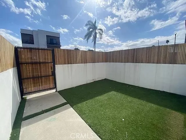 Enclosed front yard area with keypad entry.