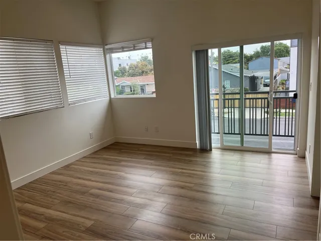 Bedroom with raised ceilings, sliding glass door, walk in closet, and balcony.