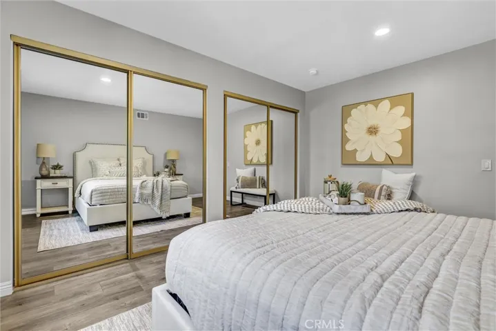 Spacious bedroom downstairs with two mirrored closets.