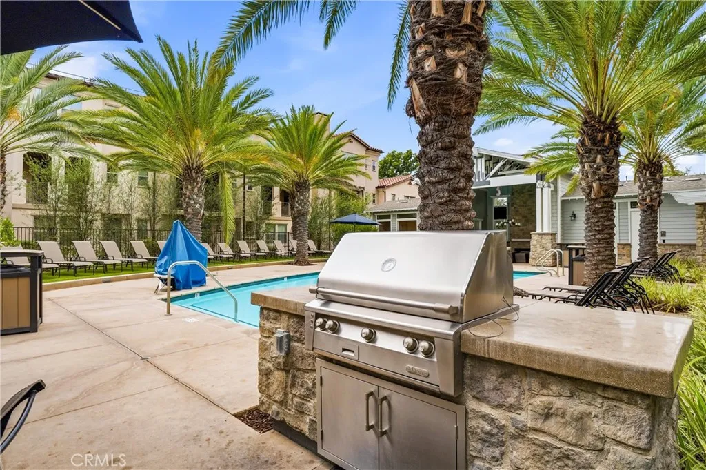 HOA common area BBQ cooking area with table, chairs, features shower, mens and women's restrooms