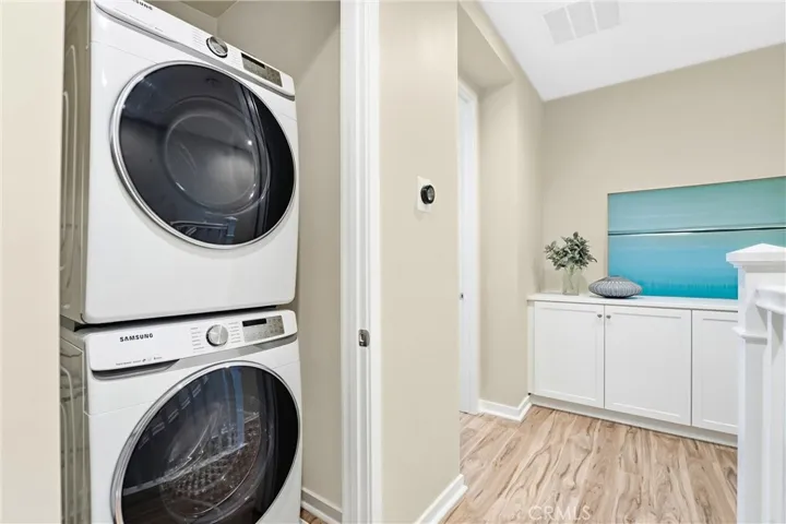 Third level stackable washer/dryer included in home