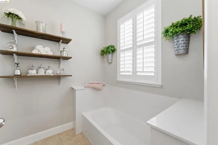Bathroom with a bath and light tile patterned floors