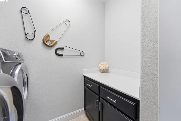Bathroom featuring a textured wall and vanity